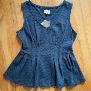 Large peplum style sleeveless top.